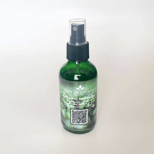 Fate Skincare's Botanic Harmony ACV Infused Toner in a 4 ounce green glass mist spray bottle with black pump, featuring Fate Skincare's iconic logo on a subtle green nature-inspired background.