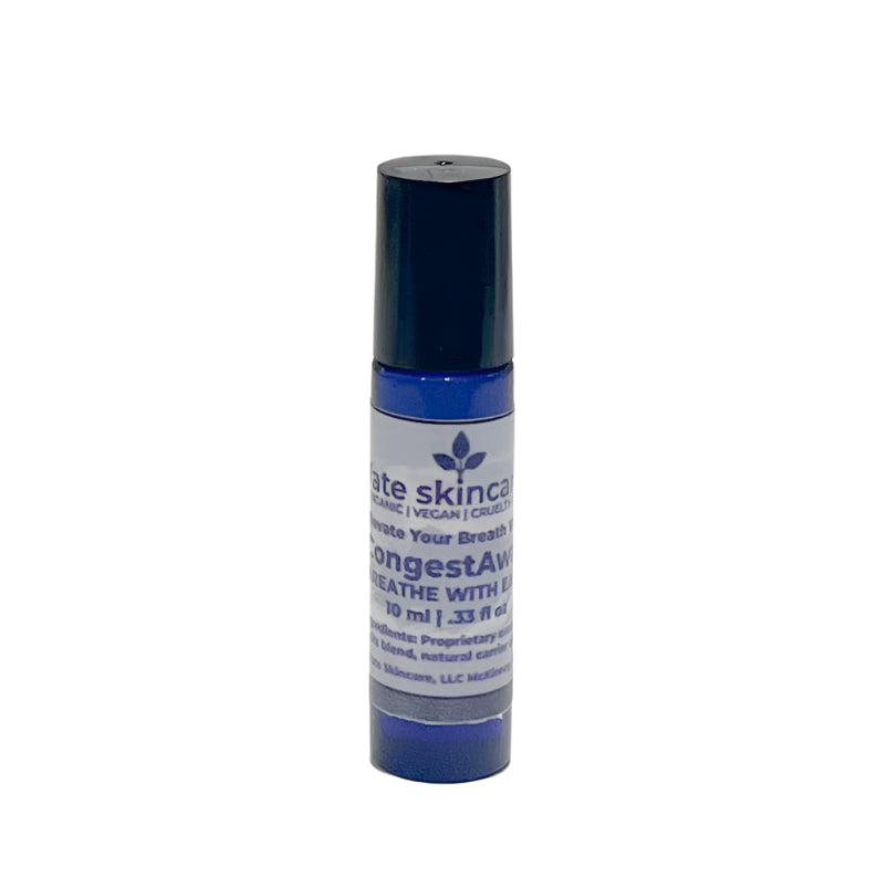 A small blue glass bottle with a black roller cap, labeled Fate Skincare CongestAway Breathe Ease Roller. The label indicates it is organic, vegan, and cruelty-free, designed to help with breathing ease. The bottle contains 10 ml (0.33 fl oz) of product.