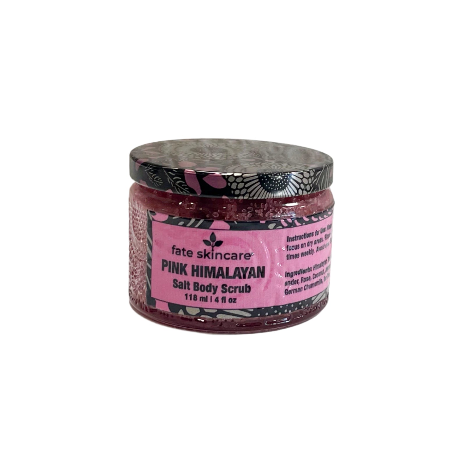 A clear glass jar of "Fate Skincare Pink Himalayan Salt Body Scrub" with a black and pink patterned lid, placed on a white surface with a textured white background. The pink label indicates that the scrub contains Himalayan pink salt and nourishing oils.