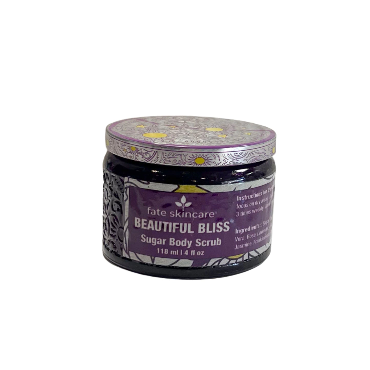  A dark glass jar of "Fate Skincare Beautiful Bliss Sugar Body Scrub" with a purple and silver patterned lid, placed on a white surface with a textured white background. The purple label highlights its sugar-based exfoliating properties.

