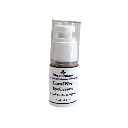  A white airless pump bottle of "Fate Skincare LumiVive Eye Cream," labeled as anti-aging, brightening, and hydrating. The label indicates that it is formulated for dark circles and puffiness.