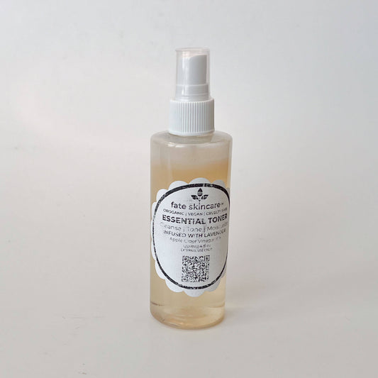 Fate Skincare's Essential Toner in a clear bottle with a white sprayer.