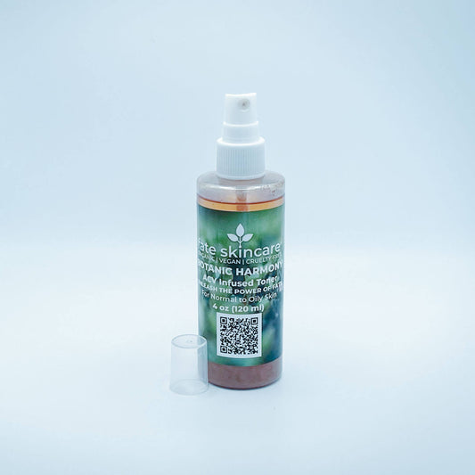 Fate Skincare's Botanic Harmony ACV Infused Toner in a 4 ounce clear mist spray bottle with white pump, featuring Fate Skincare's iconic logo on a subtle green nature-inspired background.