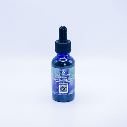 Fate Skincare's Lavender Rose Bliss Face Serum in a blue glass bottle with a black dropper, showcasing Fate Skincare's iconic logo on a subtle green nature-inspired background.